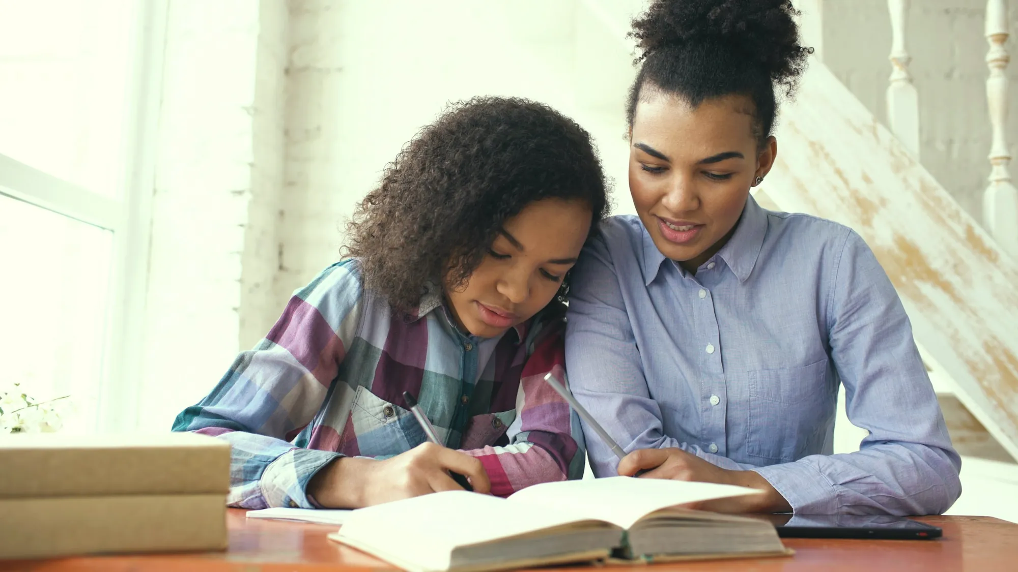 An adult and a young person looking at a laptop together